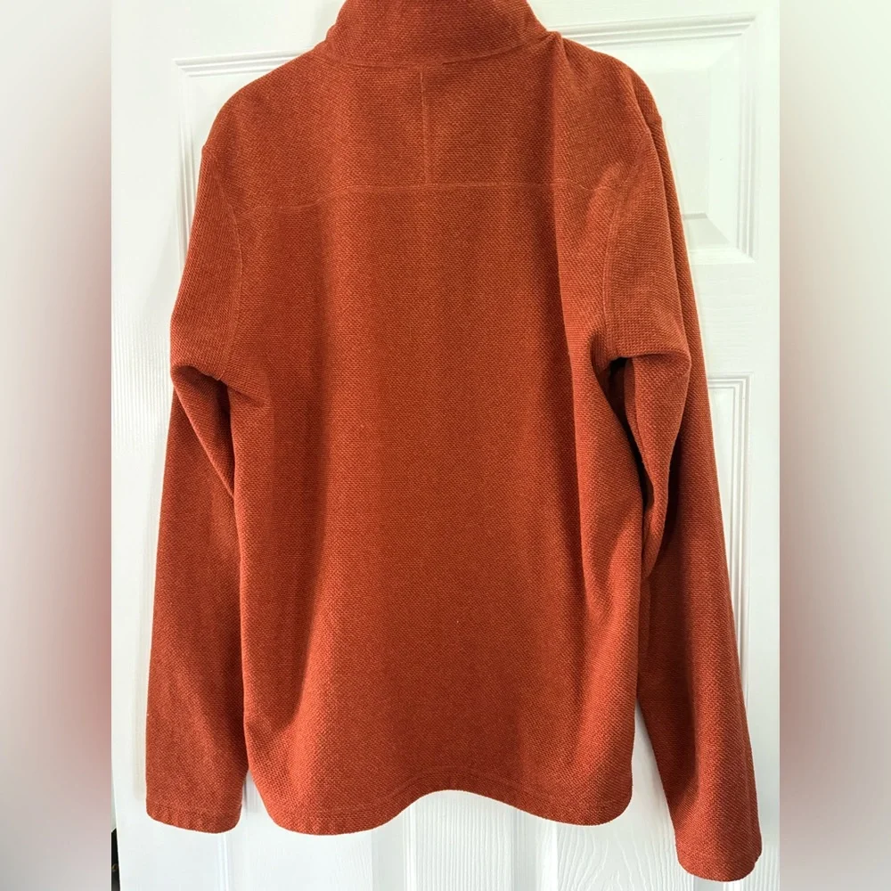 The North Face Textured Cap Rock Quarter Zip Pullover in a rust color